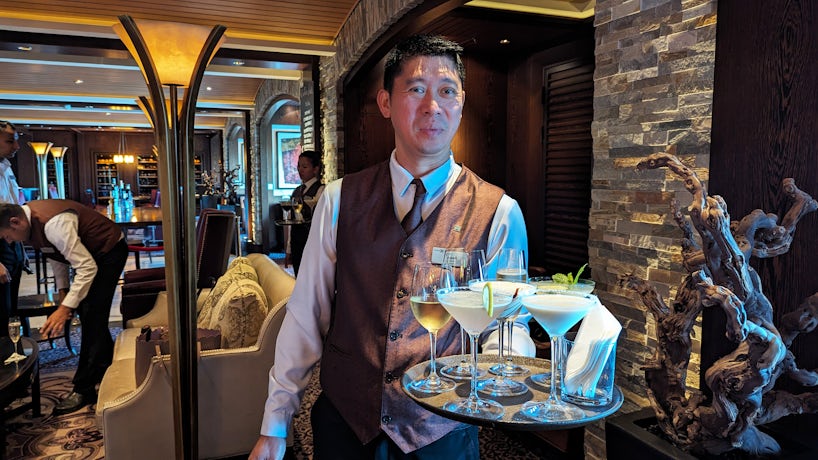A waiter serves drinks on Celebrity Reflection. (Photo: Colleen McDaniel)
