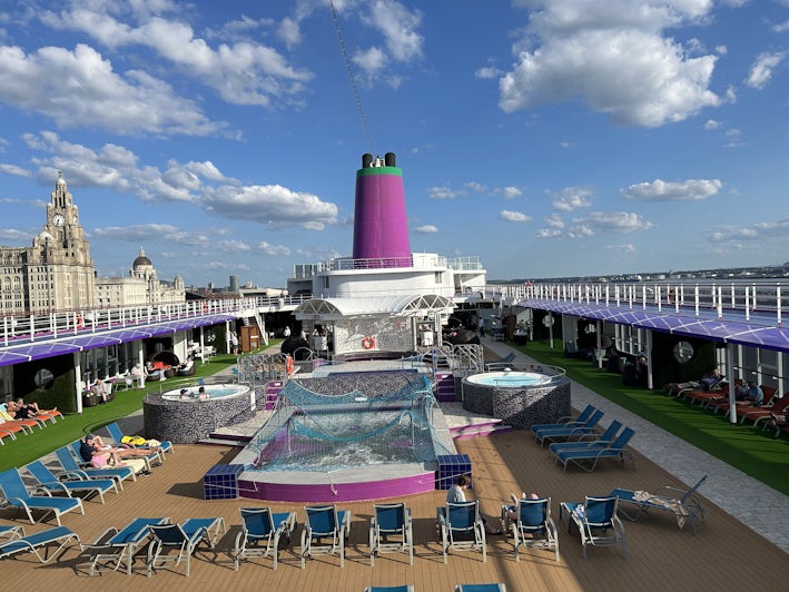 The main pool deck on Ambassador Ambition with Liverpool in the background
