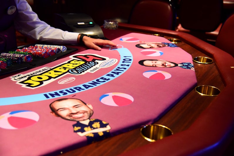 Close-up shot of a Jokers-themed poker table on Impractical Jokers Cruise 4