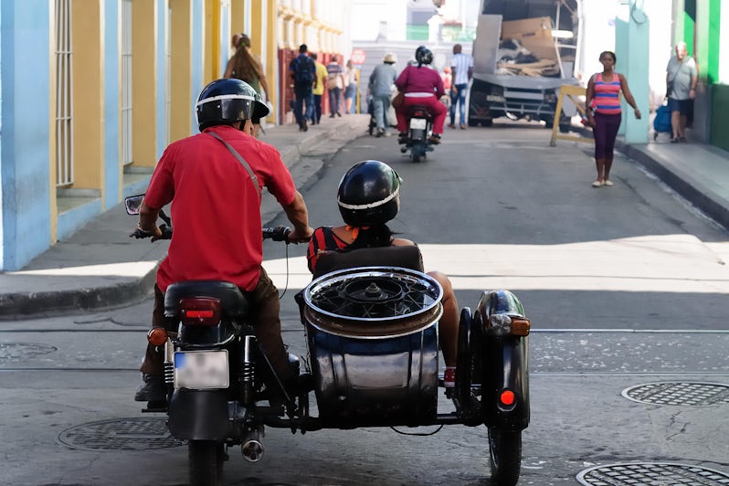 Man and woman on a sidecar bike for a sidecar tour in Cuba