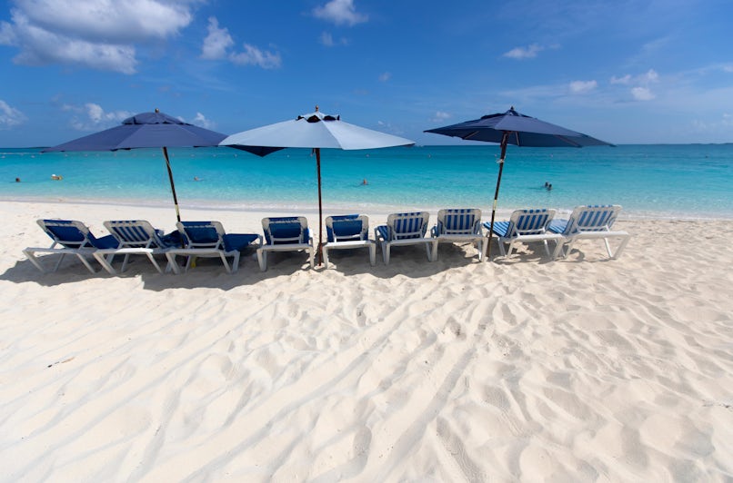 Beach chairs and umbrellas along Cabbage Beach in Nassau on a sunny day