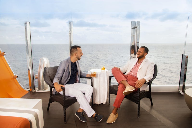 A couple relaxes with drinks on the Magic Carpet on Celebrity Edge. (Photo: Naima Green/AIPP)
