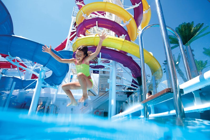 Young girl jumping into a pool at the water park on Norwegian Breakaway