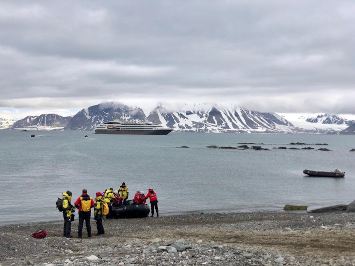 Expedition staff from Ponant’s ship Le Boreal help cruisers off the Zodiac in Svalbard (Photo: Chris Gray Faust )