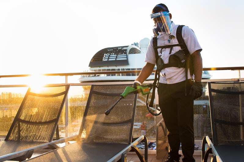 Crew member electrostatic spraying pool loungers (Photo: MSC Cruises)