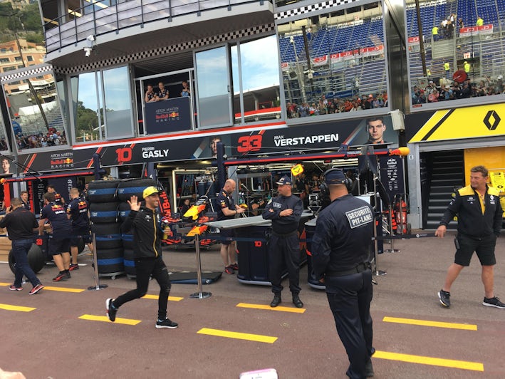Formula 1 driver Daniel Ricciardo walking through the pits (in the yellow hat). Ricciardo won the Monaco Grand Prix in 2018. This is a real treat to see him. Photo by Liz Ciccone.