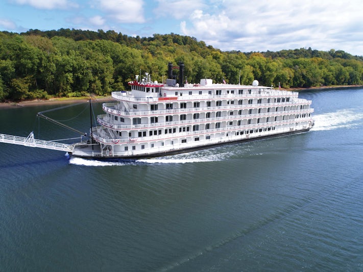 Exterior aerial shot of Queen of the Mississippi cruising down a North America river