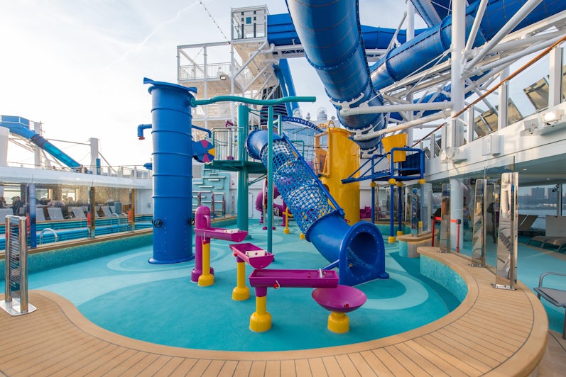 Shot of the colorful pool and slides at the Aqua Park on Norwegian Encore on a cloudy day, without passengers