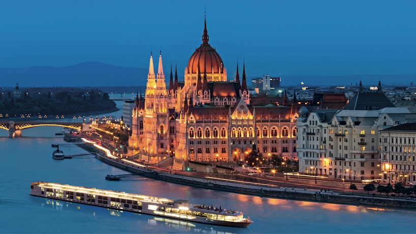 River cruise ship Scenic Jade sails the Danube River past the parliament building in Budapest at night. (Photo: Scenic Cruises)