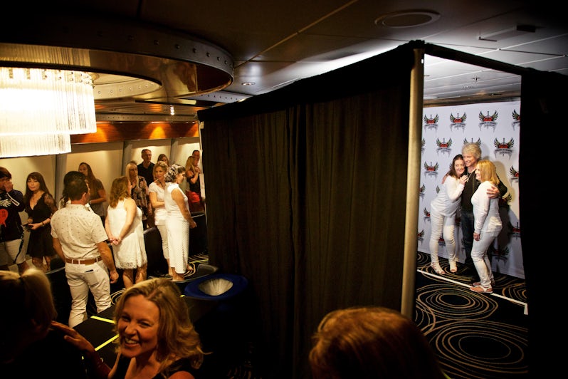 Fans posing with Bon Jovi for a picture at an onboard meet and greet session