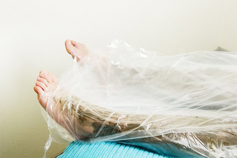 A detail image of the feet wrapped in during a sea mud full body wrap at a luxury spa.