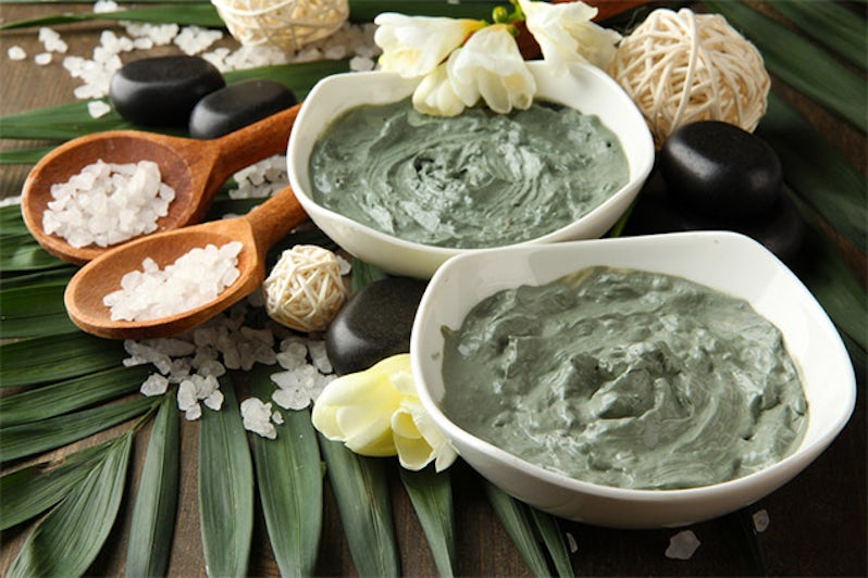 Two bowls of green spa treatment mixture