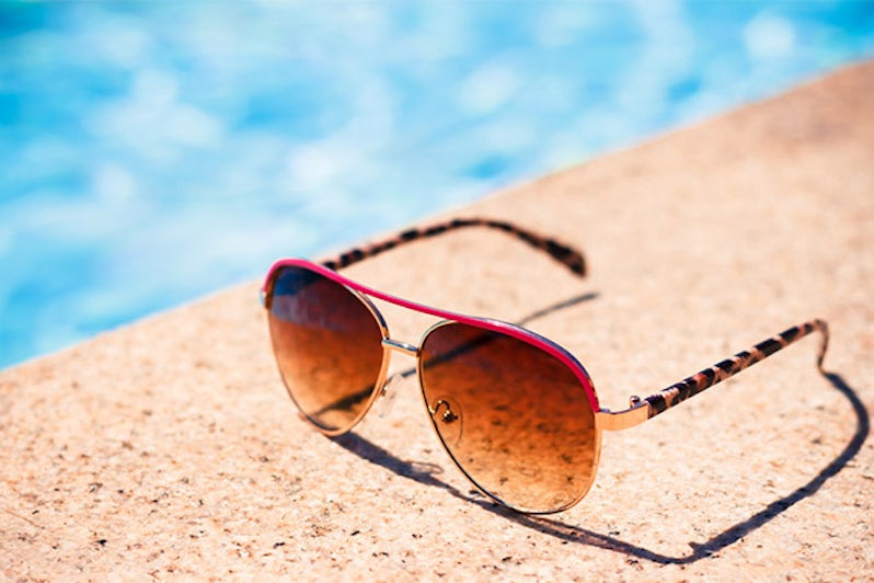 Brown funky sun glasses near swimming pool