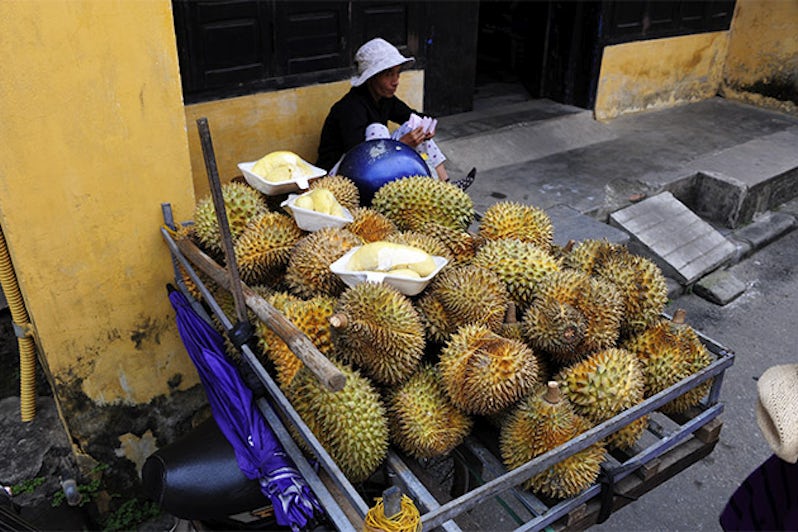 Local with a wagon full of durian fruit