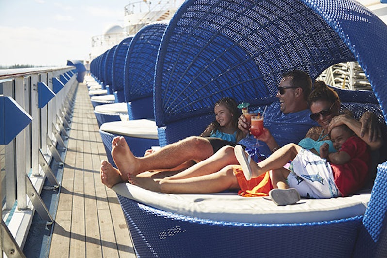 Family lounging in an upper pod on a Carnival cruise deck