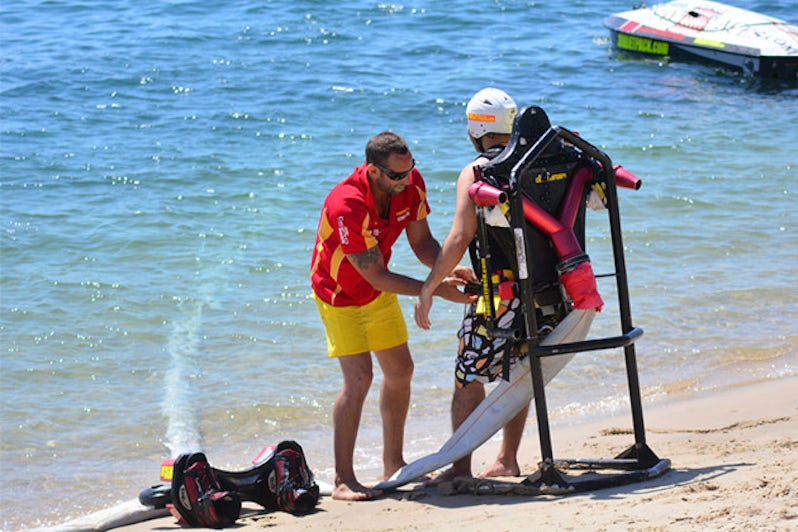 An instructor prepares a client for flyboarding
