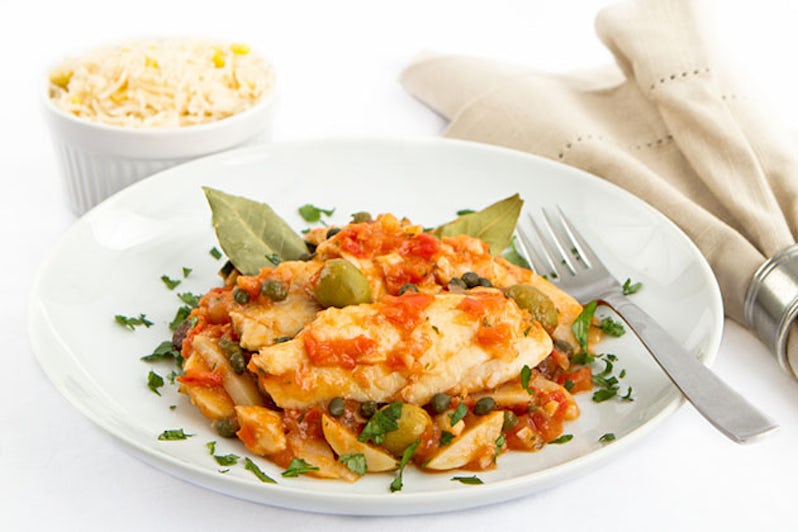 The Tides' Steamed Bajan Flying Fish Seasoned and Braised in a Rich Tomato Creole Sauce