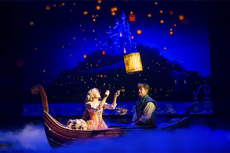 Characters from Tangled musical releasing a lantern from a small paddle boat