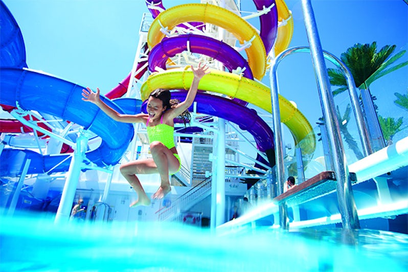 Young girl jumping into a pool on Norwegian Cruise Line