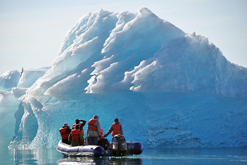 Skiff exploring glacial ice in Alaska