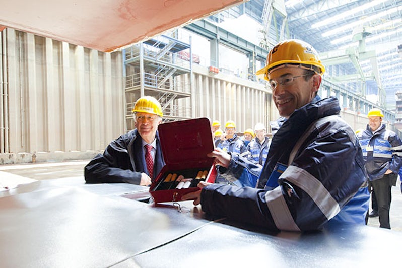 Freshly minted coins being placed at a Royal Caribbean keel laying ceremony