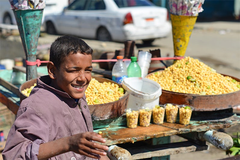 The child street vendor sells chickpea snack in Cairo, Egypt