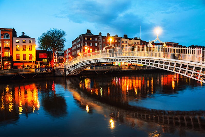 Night view of famous illuminated Ha Penny Bridge in Dublin, Ireland