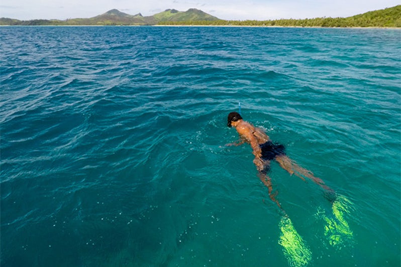 Young man snorkeling in Fiji's Yasawa islands