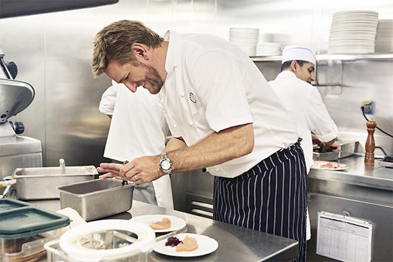Action shot of Curtis Stone cooking