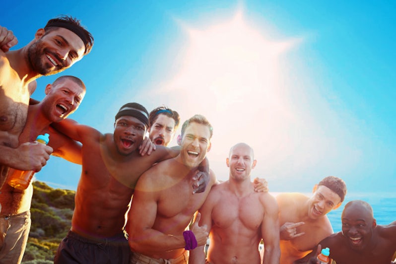 Eight shirtless men on rocky bluff