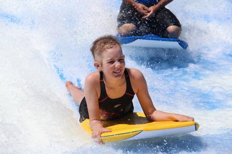 girl with cancer rides flowrider on royal caribbean ship camp quality