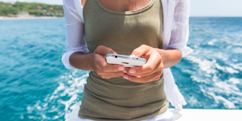 Women Using Smartphone on Cruise (Photo: Maridav/Shutterstock)