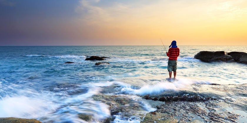 Man Fishing at Shore (Photo: isarescheewin/Shutterstock)