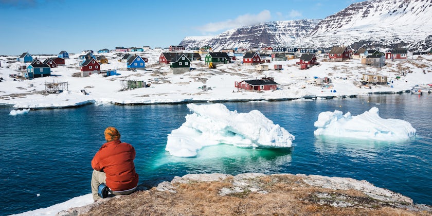 Man Enjoying the View of Qeqertarsuaq, a Small Town of Greenland in Early Spring Time (Photo: Yongyut Kumsri/Shutterstock)