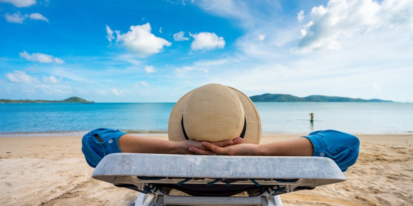 Woman Enjoying Vacation by Beach (Photo: PIXA/Shutterstock)