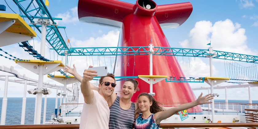 Family Posing in Front of Ships Funnel (Photo: Carnival Cruise Line)