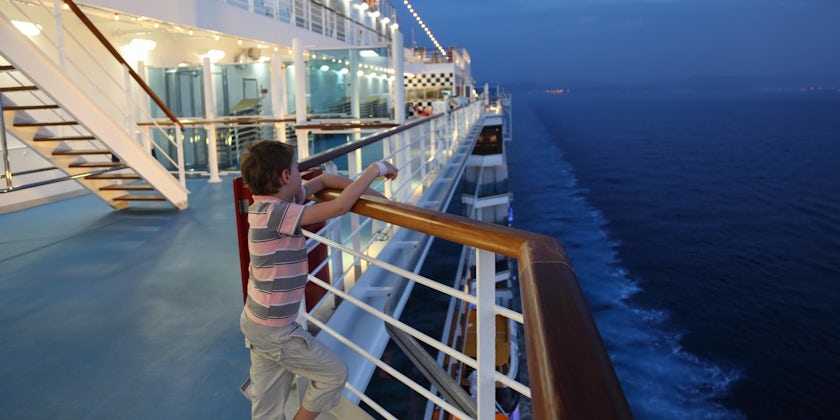 Child on a cruise ship at night (Photo: Pavel L Photo and Video/Shutterstock.com)