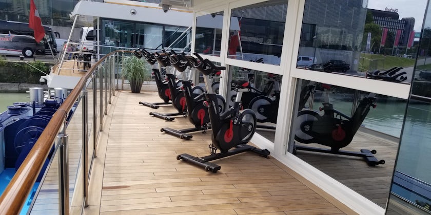 Row of spin bikes on the exterior deck on AmaMagna