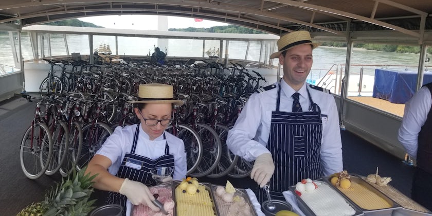 Two staff members serving gelato on the sun deck of AmaMagna
