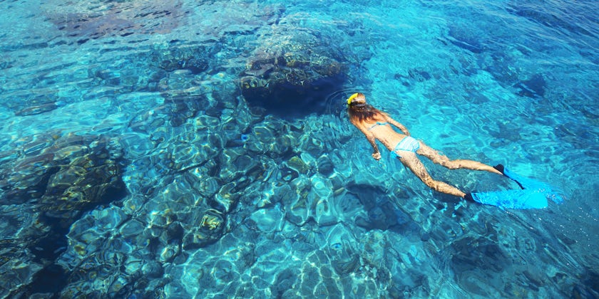 Woman Snorkeling in the Open Clear Blue Waters (Photo: Dudarev Mikhail/Shutterstock)