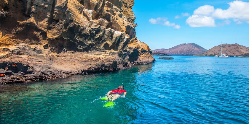 A Man Swims Near the The Galapagos Islands (Photo: FOTOGRIN/Shutterstock)