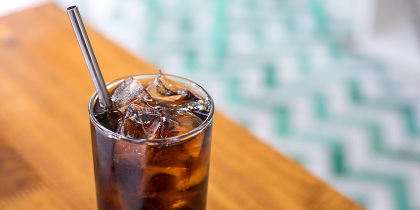 Reusable Metal Straw in Glass Filled With Soda (Photo: VDB Photos/Shutterstock)