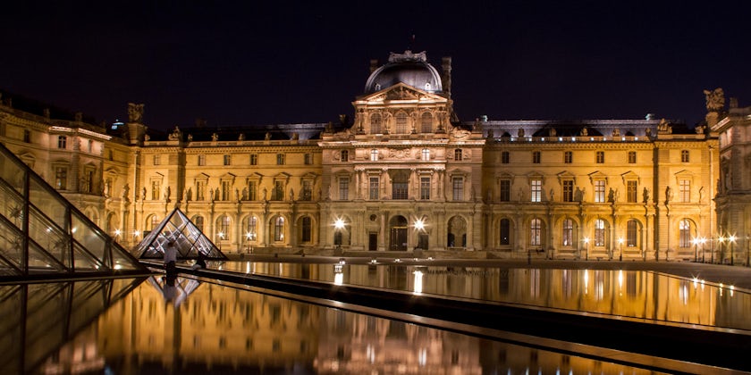 The Louvre in Paris, France shot at night with reflections from the pools (Photo: Nigel Wiggins/Shutterstock)