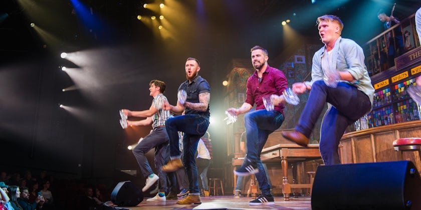 Four male performers dancing onstage for Choir of Man on Norwegian Encore (Photo: Cruise Critic)