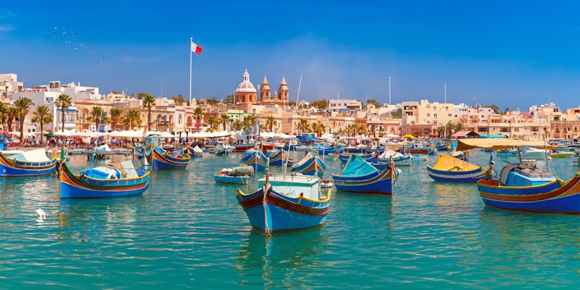 Traditional eyed colorful boats Luzzu in the Harbor of Mediterranean fishing village Marsaxlokk, Malta (Photo: kavalenkava/Shutterstock)
