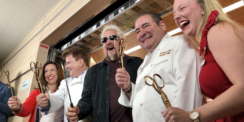 Christine Duffy, Rudi Sodamin, Guy Fieri and two other people smiling and holding gold scissors at the culinary ribbon-cutting ceremony on Carnival Panorama