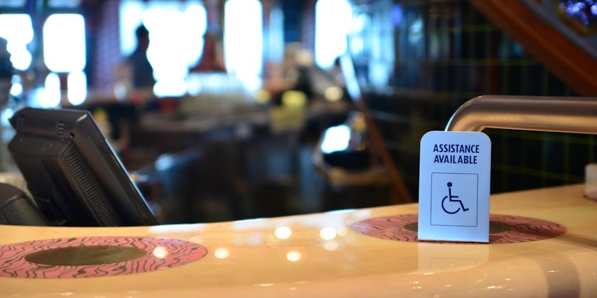 Bar counter and a special needs sign at cruise ship (Photo: Igor_Koptilin/Shutterstock)