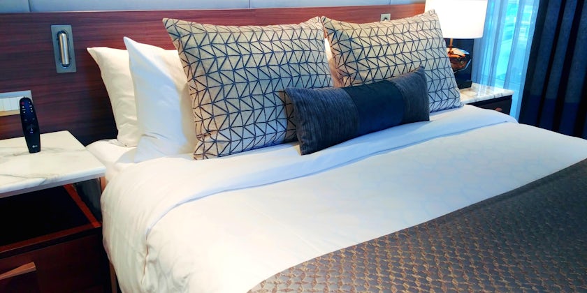 Close-up shot of a bed in a balcony cabin on Sky Princess