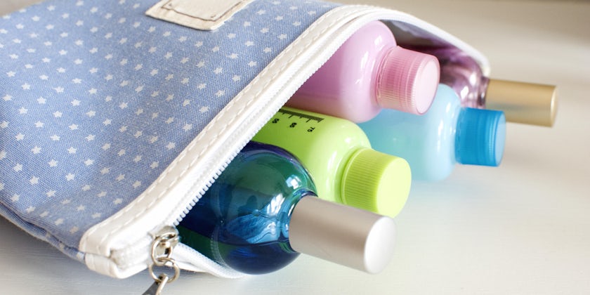 Close-up shot of an open toiletry bag, filled with small bottles of soap and shampoo