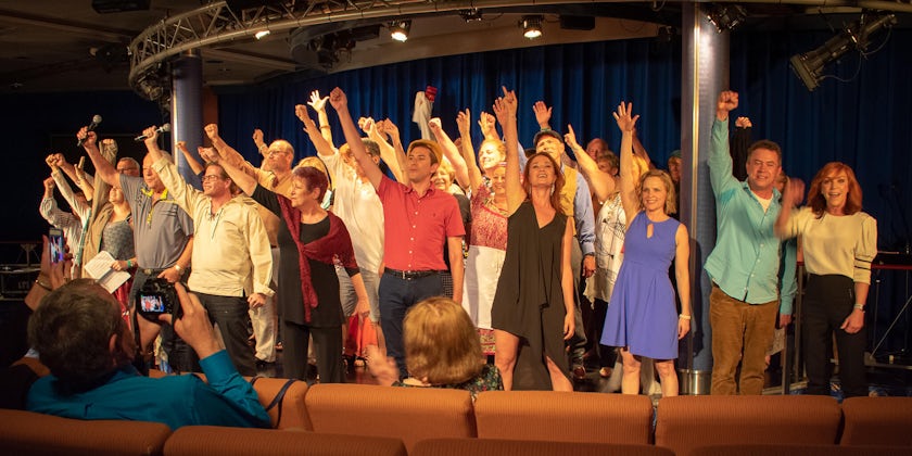 Passengers singing "One Day More" with Sierra Boggess (Photo: Seth's Big Fat Broadway Cruises)